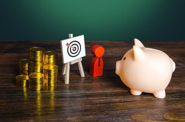 The Beginner's Guide To Profitable Amazon Affiliate Marketing In 2024 image 5 Pinpointing a profitable niche with stacks of coins a piggy bank and target with arrow hitting bullseye MXMO The Beginner's Guide To Profitable Amazon Affiliate Marketing In 2024 image 5 Pinpointing a profitable niche with stacks of coins a piggy bank and target with arrow hitting bullseye MXMO