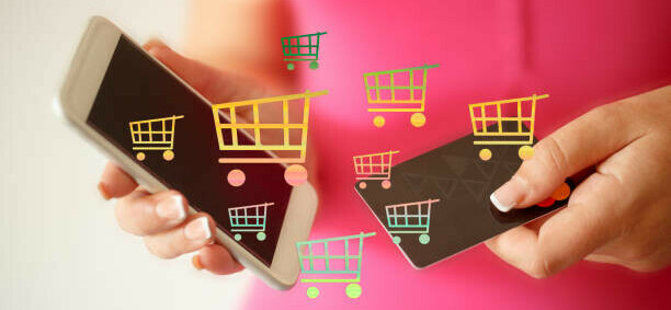 How To Make Money On Tiktok A Beginners Guide image 6 person holding 2 phones with digital shopping baskets across the screen make xtra money online