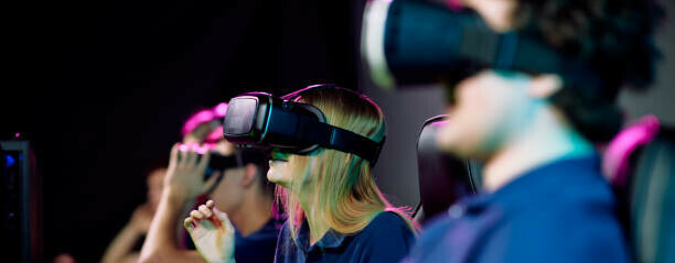 Learn How To Make Money In The Gaming Industry A Gamer's Guide image 9 people sat with VR headsets make xtra money online