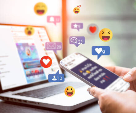 10 Proven Ways Influencers Make Money On Social Media image 2 laptop and mobile phone with social media likes and emojis make xtra money online